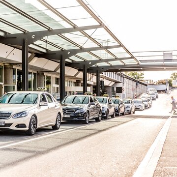 Wartende Taxis vor dem Terminal des Flughafens Stuttgart unter verglaster Überdachung